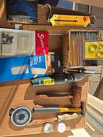 Overview of all tools, driver, sandpaper, sewing kit, buttons, key rings, rulers, mallet, hammer, discs