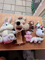 Group view of all six plush items on table