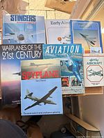 Group shot showing all eight aviation and warplane books