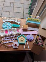 Full lot on table showing multiple Barbie furniture and accessory pieces