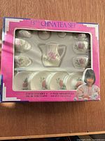 Front of boxed 13-piece china tea set showing contents