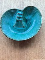 Top view showing teal/turquoise glazed interior and three cigar rests