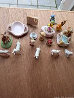 Group shot of all 14 ceramic pieces on wood surface
