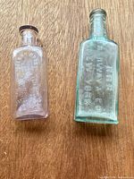Both bottles front view on wood surface