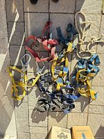 Top view of harnesses, lanyard, rope on stone surface