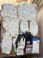 Overview of all packaged gloves and poncho on table