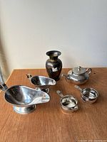 Group shot of all six metal items on table