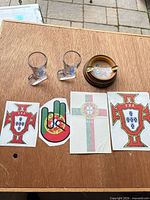 Entire lot: two shot glasses, wood ashtray, four stickers