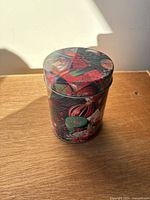 Single tin with lid on showing Christmas imagery