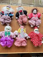 Group shot of six Hubaco clown dolls