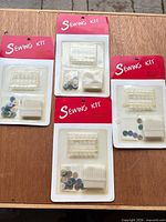 Front view of the four sealed sewing kits on blister cards