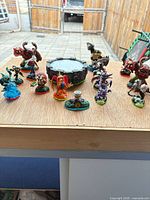 Group shot of 14 figures arranged around Portal of Power base