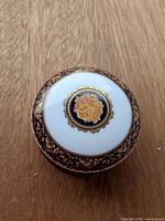 Top view showing gold floral medallion and gilt navy border