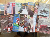 Group view of all 18 Toy Farmer magazine issues spread out