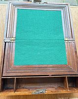 Closed view of lap desk showing green felt writing surface and wood trim