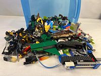 Wide view of piled assorted LEGO pieces in blue tote
