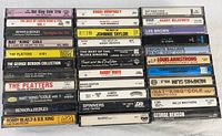 Four vertical stacks of cassette tapes showing 44 titles