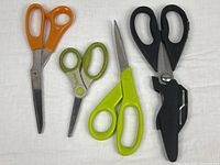 All four pairs of scissors laid out on white background
