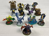 Group shot of all 13 Skylanders figures on white surface