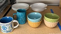 Two Starbucks mugs, four pastel ice-cream bowls, five Corelle bowls, two CorningWare au gratin dishes