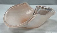 Side profile showing freeform folded rim and color gradient