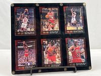 Front view of six Michael Jordan Upper Deck cards in black screw-down holder
