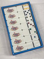 Front view of sealed domino set showing Las Vegas logo tiles and color dots