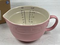 Left side view showing pink exterior, white interior with scale