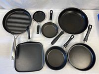 Group shot of seven non-stick pans and griddles