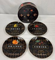Set of four plates and storage box displayed
