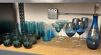 Shelf with entire assortment of blue and teal glassware