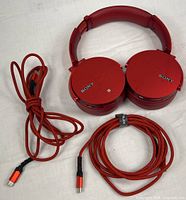 Headphones with two red braided cables displayed