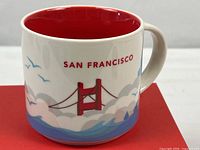 Front view of San Francisco mug showing bridge graphic and red interior