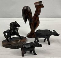 Group shot of all four carved wood animal figures