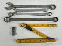 Group shot of all items: four wrenches, Snap-On socket, folding ruler