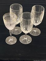Group of four goblets: three matching Waterford, one gold-rimmed