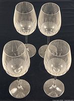 Four Waterford crystal wine goblets on black background