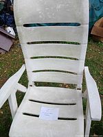 High-back white resin patio chair front view