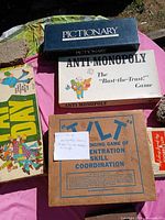 Box lids of Pictionary, Anti-Monopoly, Payday, Tilt