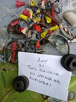 Pile of wire nuts, hose clamps and small connectors with handwritten lot note