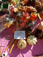 Assorted autumn wreath, decorative pumpkins, candles and bagged florals