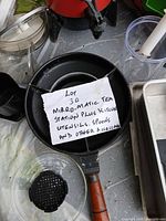 Overview showing pan holding lot label and surrounding utensils