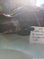 Exterior of torn black box with Innovative Fixtures for Life branding