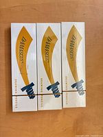 Front view of the three boxed Damascus drawing pencils