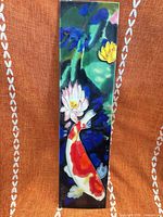 Front of ceramic wall tile showing koi fish and lotus design