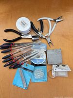 Overview of pliers, files, bench block, cord spool, findings packaging