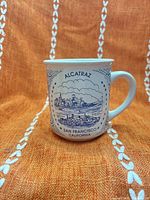 Front view showing Alcatraz and skyline graphic on mug