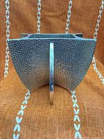 Front view showing hammered texture, concave sides, and ring detail