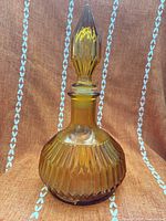Full view of amber glass decanter with stopper