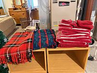 All towels and blankets stacked on wooden cubbies